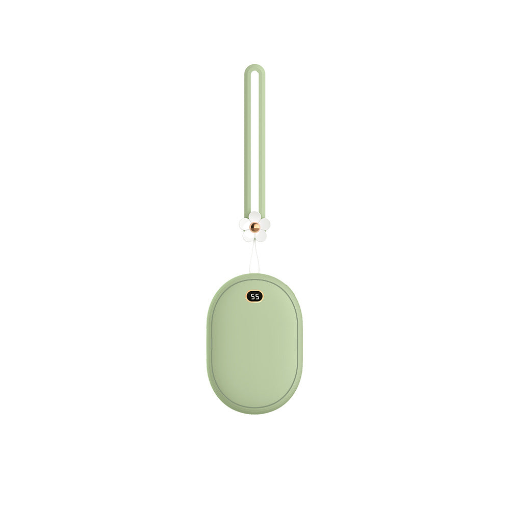 Mini sage green power bank/hand warmer, oval-shaped, with a digital display (55) and a flower charm on the lanyard.