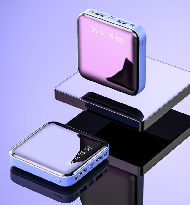 Square, mini power bank with a reflective mirror surface, light blue trim, and a digital battery level display.