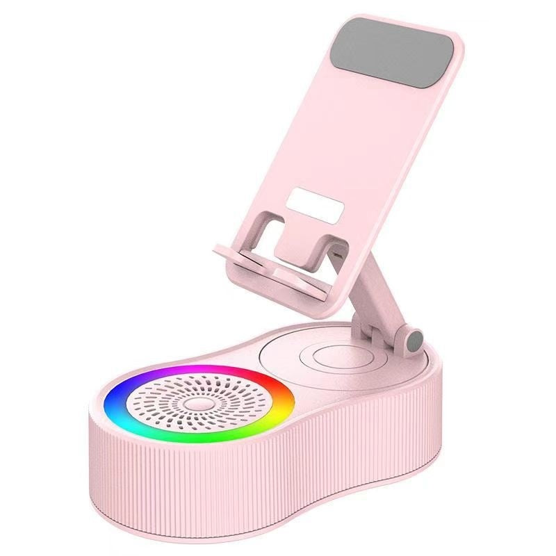 Pink adjustable phone stand and multi-function hub with a ribbed base, integrated speaker, and a vibrant rainbow LED light ring.