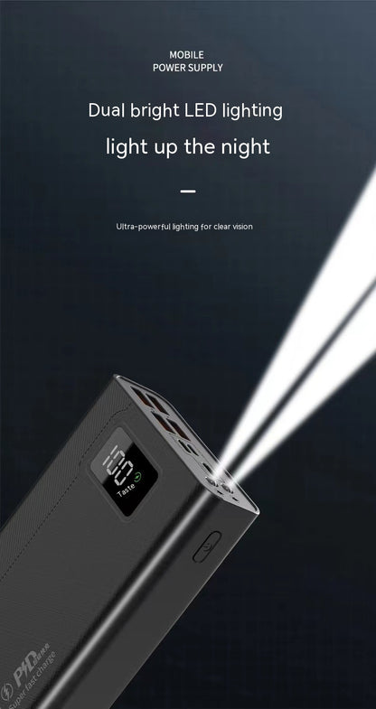 A black power bank with a digital display showing 100%, featuring dual bright LED lights illuminating the dark background.